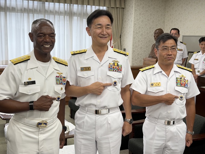 Three men receiving pins